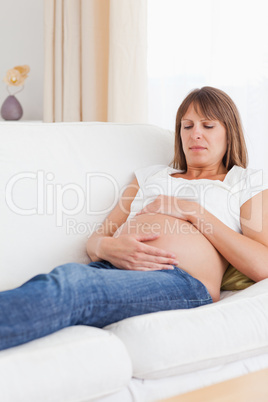Portrait of a pregnant woman lying on a sofa