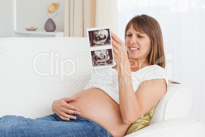 Pregnant woman looking at her baby's ultrasound scan