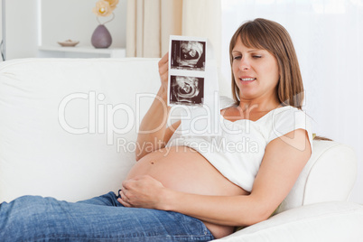 Close up of a pregnant woman looking at her baby's ultrasound sc
