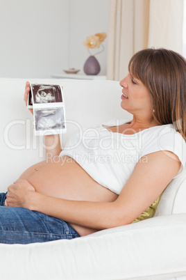 Close up of a pregnant woman looking at her baby's ultrasound sc