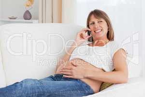 Close up of a pregnant woman phoning
