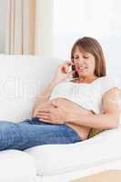 Portrait of a pregnant woman phoning