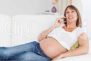 Relaxed pregnant woman phoning