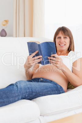 Portrait of a pregnant woman reading a book