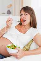 Close up of a pregnant woman eating a salad