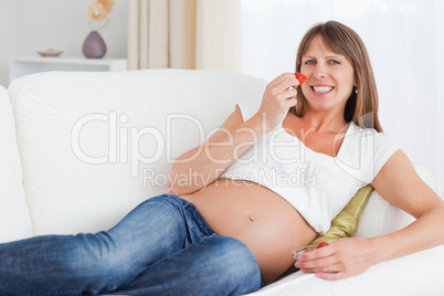 Pregnant woman eating strawberries