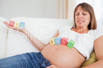 Mother to be chilling out with toys