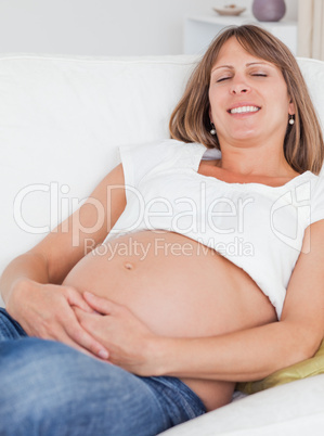 Charming pregnant woman posing while lying