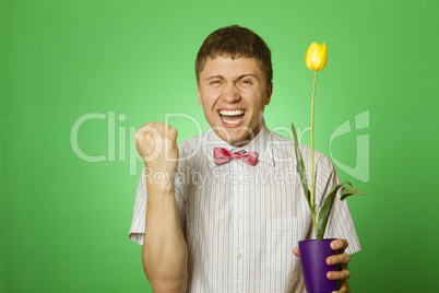 Man holding a tulip grown in a pot