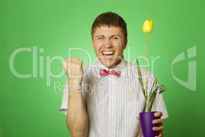 Man holding a tulip grown in a pot