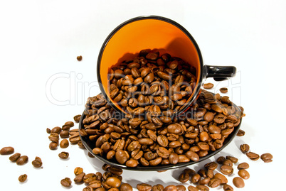 cup and saucer with the coffee beans isolated on white