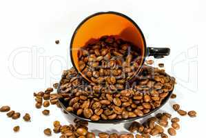 cup and saucer with the coffee beans isolated on white