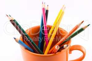 colored pencils in a cup isolated on white