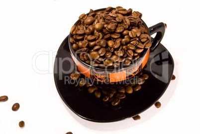 cup and saucer with the coffee beans isolated on white