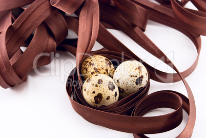 quail eggs and ribbon isolated on white