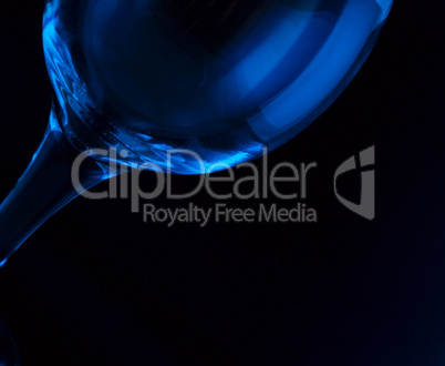 conceptually lighted wine glass on a black background