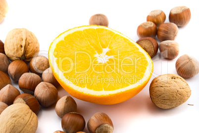 orange and hazelnuts isolated on white