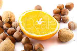 orange and hazelnuts isolated on white