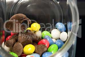 Teddy Bear  and chocolates in a glass jar