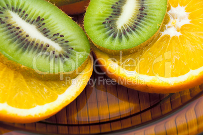 kiwi fruit and oranges on a plate