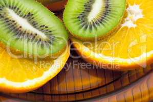 kiwi fruit and oranges on a plate