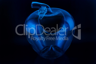 conceptually illuminated glass apple on a black background
