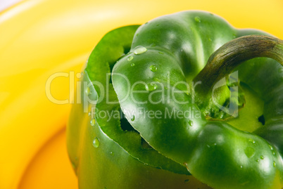 green pepper on a plate isolated on white