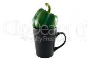 green peppers in a black cup isolated on white