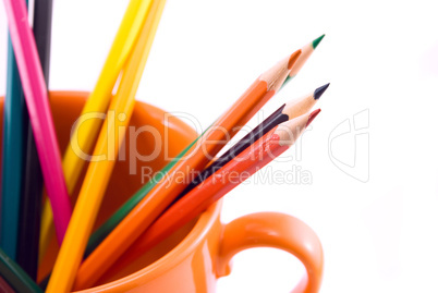 cup with colored pencils isolated on white