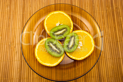 kiwi fruit and oranges on a plate