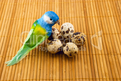 bird  and quail eggs on a bamboo mat