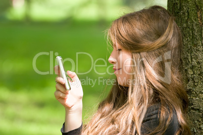 attractive girl with phone in park