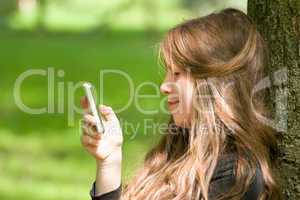 attractive girl with phone in park