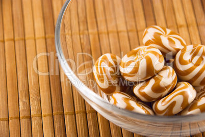 a bowl of candy on a bamboo mat