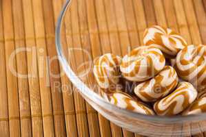 a bowl of candy on a bamboo mat