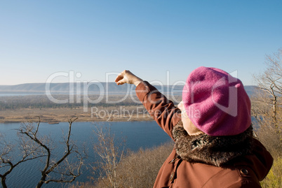 Woman holds a hand over the mountain