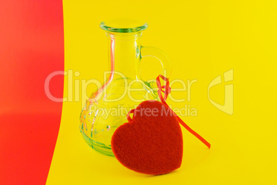 glass bottle and the heart on a colorful background