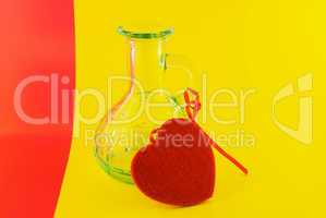 glass bottle and the heart on a colorful background