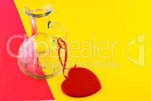 glass bottle and the heart on a colorful background