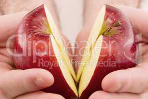 half an apple in  hands isolated on white