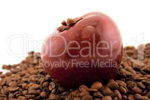 red apple and coffee beans isolated on white