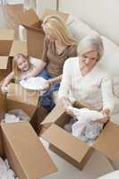 Female Generations of Family Unpacking Boxes Moving House