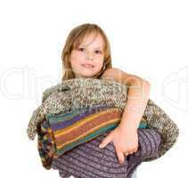 little girl with stack of sweaters
