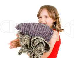 little girl with stack of sweaters