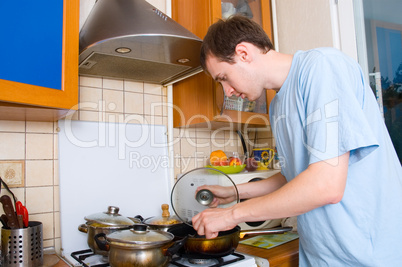 young man preparing food in the kitchen