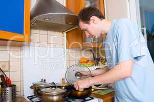 young man preparing food in the kitchen