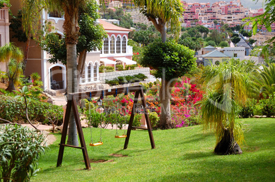 Swing on the green lawn at luxury hotel, Tenerife island, Spain