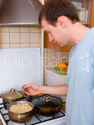 young man preparing food in the kitchen