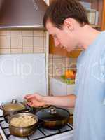 young man preparing food in the kitchen