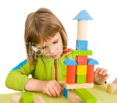 child plays with toy blocks